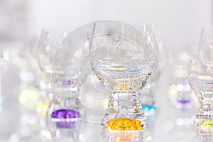 Glassware for drinks. Colored glasses. Background with glass wine glasses