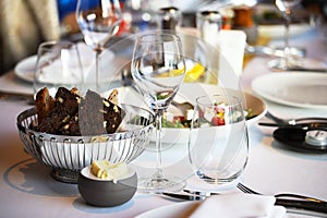 Glassware, glasses for white wine on a table in a restaurant. Banquet, cutlery, table setting. photo