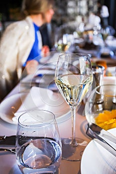 Glassware, glasses for white wine on a table in a restaurant. Banquet, cutlery, table setting. photo