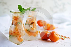 Glassware with refreshing citrus mandarine mint fruits cocktail, detox water