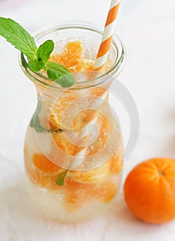 Glassware with refreshing citrus mandarine mint fruits cocktail, detox water