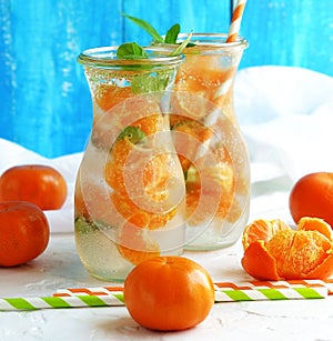 Glassware with refreshing citrus mandarine mint fruits cocktail, detox water