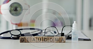 Glaucoma written on background of glasses for vision and eye drops closeup 4k movie