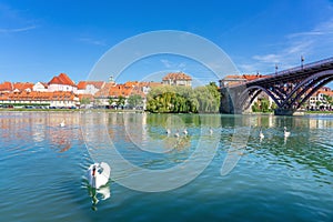 Glavni old most in Maribor with a beautiful view of the old town end lent district summer day with swans