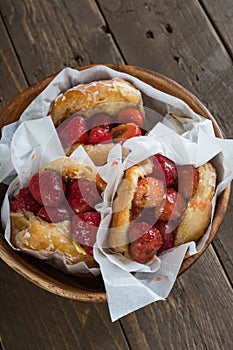 Glazed donut with mouth watering sweet strawberries