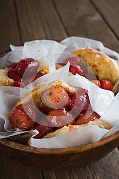 Glazed donut with mouth watering sweet strawberries