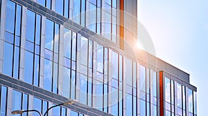 The glazed facade of an office building with reflected sky.