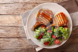 Glazed grilled steak with fresh salad of vegetables and leaves c