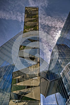 Glazed office building with reflections of other buildings