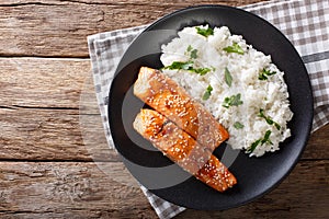 Glazed salmon fillet with rice garnish close-up. horizontal top