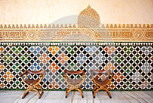 Glazed tiles, azulejos, medieval chairs, Alhambra palace in Granada, Spain photo