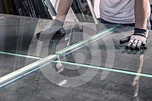 Glazier breaking glass on a professional table