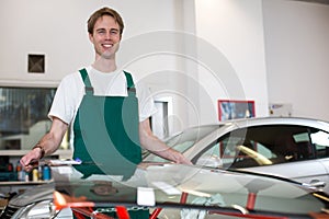 Glazier with car windshield made of glass