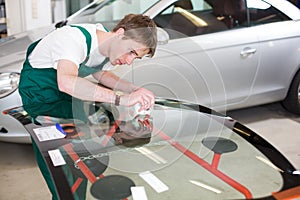 Glazier with car windshield made of glass