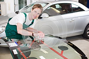 Glazier with car windshield made of glass