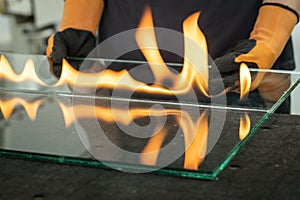 Glazier cuts safety glass, VSG Very Safe Glass The fire burns through the foil connecting the panes