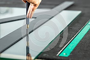 A glazier cuts thick glass on a specialized table, Concept, Glass work