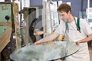 Glazier grinding a pieco of glass