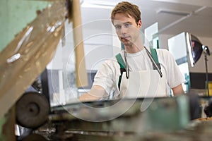 Glazier grinding a pieco of glass