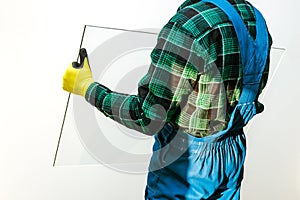 Glazier holding in his hands the panes of transparent glass