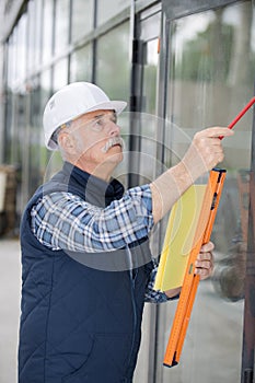 Glazier inspecting wall glass