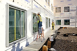 A glazier sealing newly installed windows.