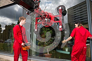 Glazier operating glass installation crane