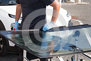 Glazier removing windshield or windscreen on a car