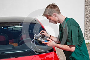 Glazier repairing windscreen after stone chipping damage