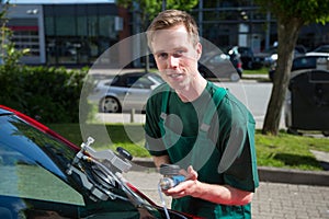 Glazier repairing windscreen after stone chipping damage