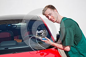 Glazier repairing windscreen after stone chipping damage