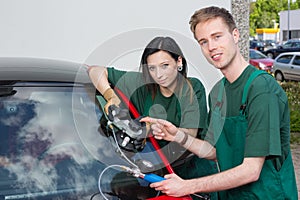 Glazier repairing windscreen after stone chipping damage