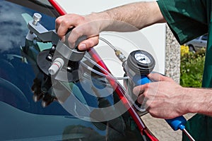 Glazier repairing windscreen after stone chipping damage