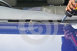 Glazier using tools repairing to fix crack broken windshield, wi