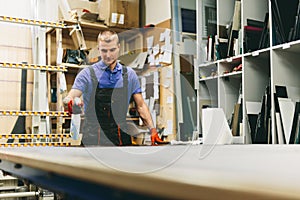 Glazier worker cleaning glass in workshop. Industry