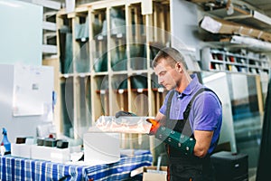 Glazier worker cutting glass with fire in a workshop
