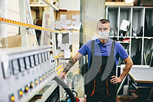 Glazier worker in face mask. Industry and work during coronavirus Covid-19