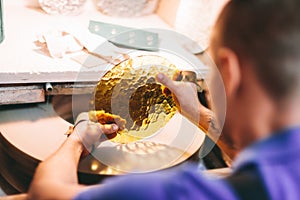 Glazier worker polishing glass in workshop. Industry