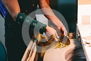 Glazier worker polishing glass in workshop. Industry