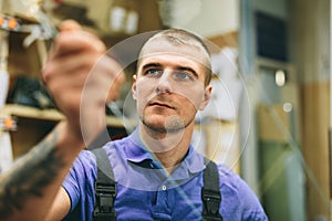 Glazier worker preparing glass in workshop. Industry