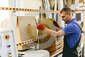 Glazier worker preparing glass in workshop. Industry