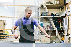 Glazier worker preparing mirror glass in workshop. Industry