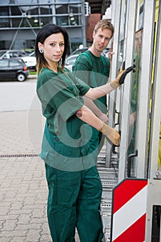 Glaziers with glass transportation truck