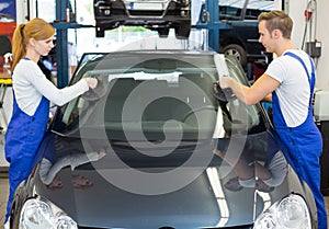 Glaziers replace windshield or windscreen on car after stone-chipping