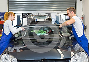 Glaziers replace windshield or windscreen on car after stone-chipping