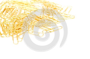 Gleaming golden paperclip isolated on white