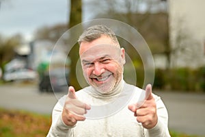 Gleeful elated man grinning broadly at the camera