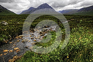 Glen Coe, Scotland, river with mountains and cloud in background