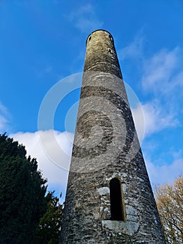 Glendalough cemetery, tower and forest in Wicklow mountains Ireland