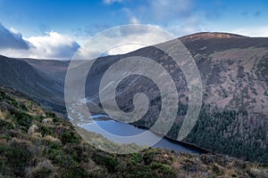 Glendalough lake and river in the valley. Hiking in Wicklow Mountains, Ireland